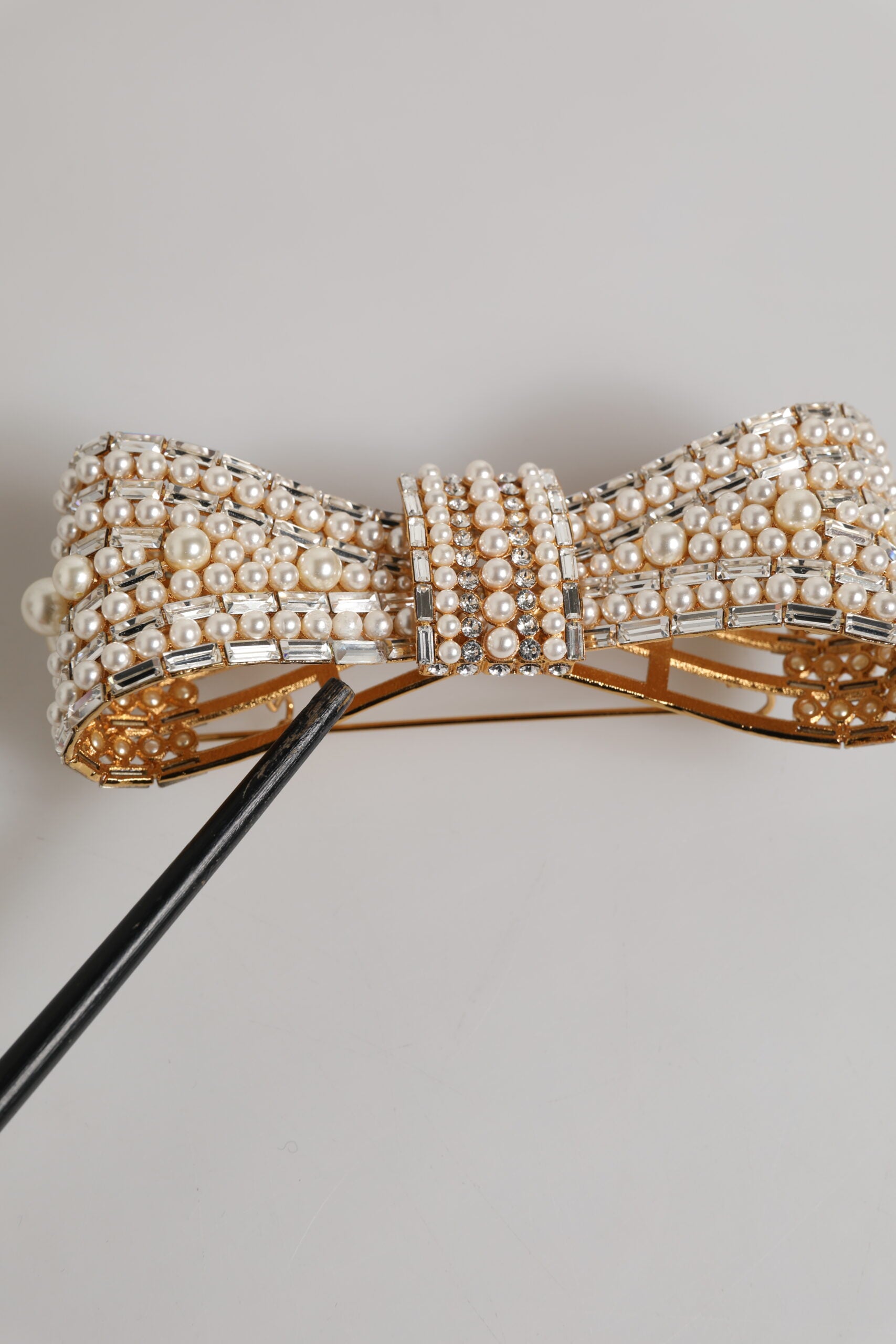 Broche Dolce & Gabbana en laiton doré, ornée d'un nœud en cristal et de fausses perles