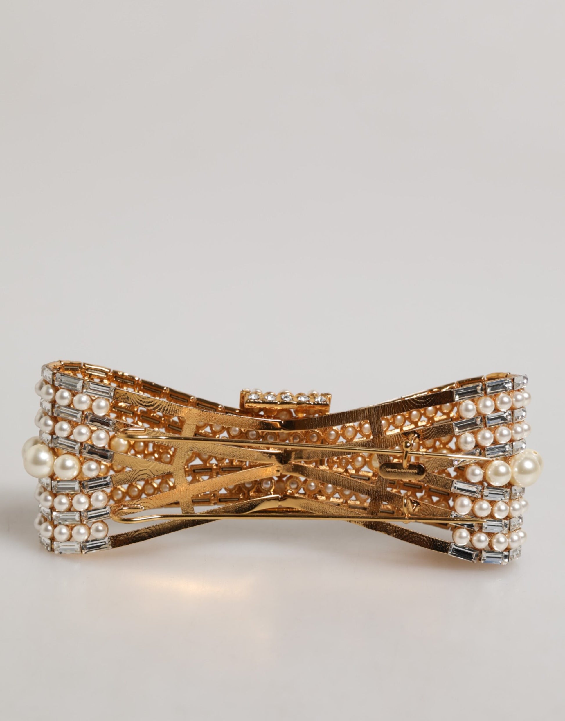 Broche Dolce & Gabbana en laiton doré, ornée d'un nœud en cristal et de fausses perles